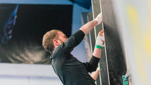 A climber with hands covered in climber's tape crack climbing at rockover climbing manchester