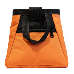 A light orange and black bouldering chalk bucket with drawstring closure and zip closure climbing accessory pockets