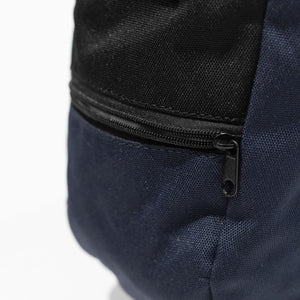 A navy blue rock climbing chalk bag with zip closure climbing accessory pocket