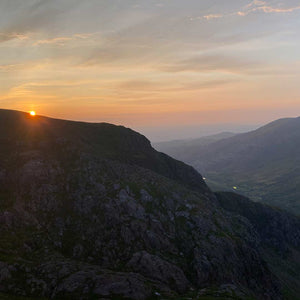 A craggy outcrop on a hill top at sunset