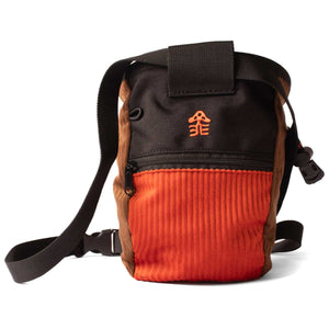 An orange and brown corduroy climbing chalk bag with a black waist strap and orange hikerdelice logo.
