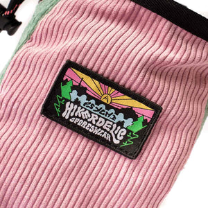 A rock climbing chalk bag with sunset mountain scene patch.