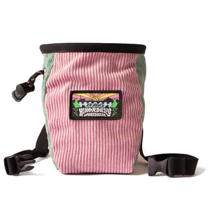 A pink and light green corduroy rock climbing chalk bag with a black waist strap.