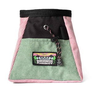 A muted pink, light green and black corduroy climbing chalk bucket bag with drawstring closure and an elastic brush holder.
