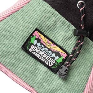 A patch sewn onto a rock climbing chalk bucket depicting a sunset mountain scene featuring the words 'psychi' and 'hikerdelic'.