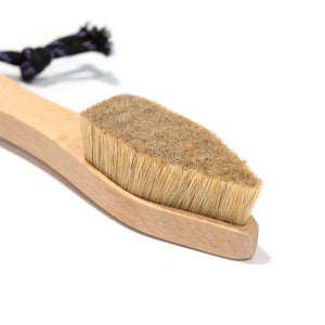 A climbing brush with triangular shaped head and blonder coloured boar hair bristles.