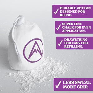 A reusable chalk ball with a drawstring opening sits amongst fine chalk powder