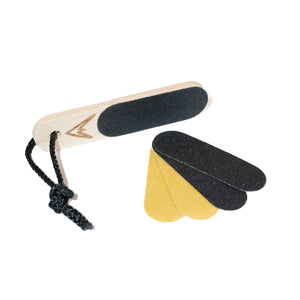 A wooden finger skin file for climbers with a black rope attachment and 4 spare sandpaper swatches