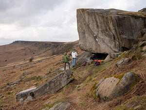 A group of climbings bouldering at Stanage Plantation in the peak district