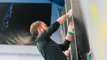 a climber at rockover climbing manchester hand jamming during a crack climbing course at the 2022 psychi climbing festival