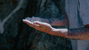 A climber's open hands covered in chalk in the sun at a climbing crag in the uk
