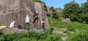 Three psychi boulderers climb a huge boulder at burbage south