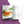 An open cookbook or recipe book laid flat on a stylized white and purple background. The left page shows a food photo of sliced orange squash on a wooden board, and the right page contains the recipe title 'Salmon Butternut Squash and Asian Rice' with ingredients and instructions.