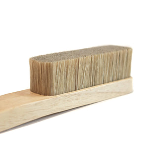 a close up of a wooden boar hair bristle bouldering brush 