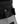A light grey and black bouldering chalk bucket with drawstring closure and climbing brush holder