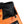 A light orange and black bouldering chalk bucket with drawstring closure and climbing accessory pockets