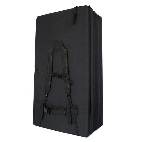 A folded up black bouldering crash pad with shoulder carry straps measuring 60cm x 110cm x 37.5cm