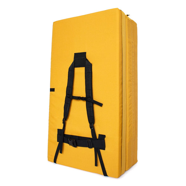 A folded yellow bouldering pad with shoulder carry straps measuring 60cm x 110cm x 37.5cm