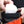 A climber putting a chalk ball into a psychi orange peak chalk bag