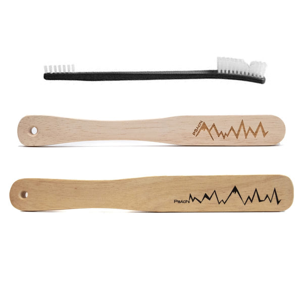 a black plastic brush and two larger wooden boar hair climbing brushes with lightning style psychi logo