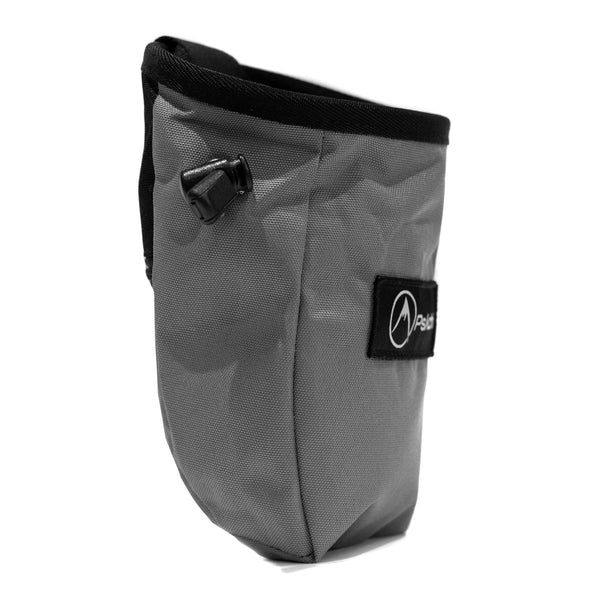 A light grey rock climbing chalk bag with drawstring closure and Pyschi white mountain logo on a black fabric patch
