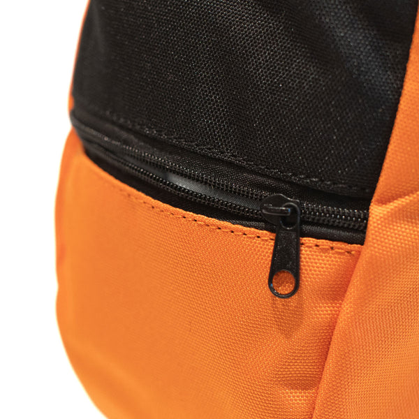 A light orange rock climbing chalk bag with zip closure climbing accessory pocket