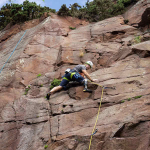 Para climber Keith Lynch ascends a rock face in North Berwick, Scotland