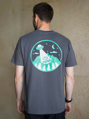Unisex t shirt for climbing, worn by male model with a wooden wall in the background.
