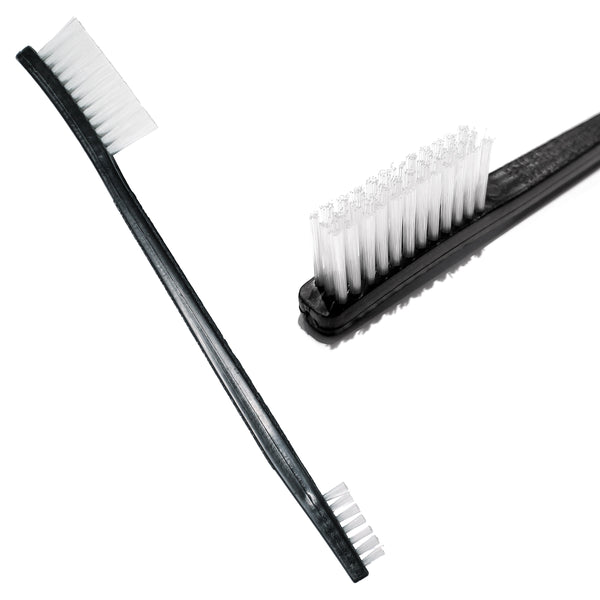 A black plastic dual ended rock climbing brush