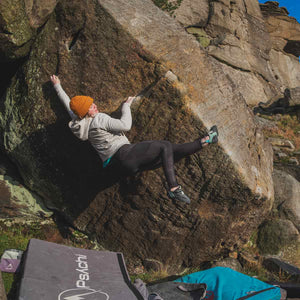 GB Climbing team coach rachel carr climbing a boulder at Stanage Edge, Peak District