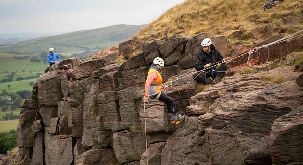 A climber prepares to abseil off a cliff at Castle Naze, Whaley Bridge.