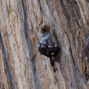 Rock climbing athlete Jen Wood climbing a cliff face at Kalymnos, Greece
