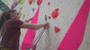 Two climbers rope climbing using a black belay bucket rope bag at a climbing centre in manchester