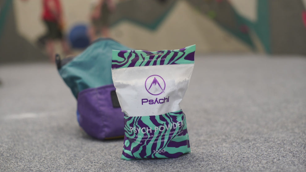 Climber tops up their bouldering chalk bag with Psych Powder climbing chalk and then climbs on an indoor climbing gym.
