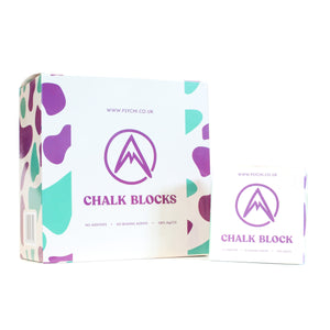 A box of chalk bocks and a single chalk block in paper packaging on a white background