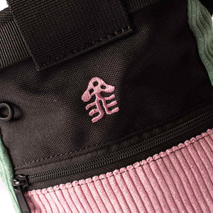 A pink embroidered mushroom logo