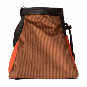 Side profile of a brown and orange corduroy bouldering chalk bucket