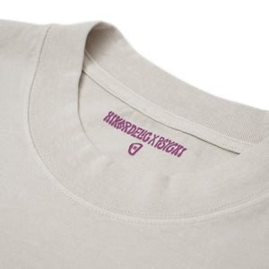 The crew neck collar of an off white oversized climbing t-shirt with purple 'hikerdelic x psychi' text and carabiner logo to show the t-shirt size.