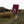 A boulderer carrying a bouldering crash mat walks up a steap path in Stanage, Peak District