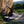 A female boulerer sit starting a problem on a bouldering pad in Stanage, Peak District