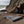 A male boulderer hanging from a rock above a bouldering pad  next to the sea at St Bees, Cumbria