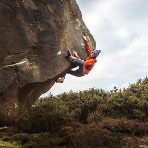 Outdoor Bouldering Athlete Sam Mawson ascending boulder problem Requiem for a Dream at Stoupe Brow, North Yorkshire