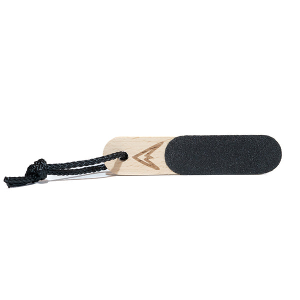 A wooden finger skin file for climbers with a black rope attachment