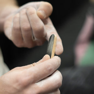 A climber at Depot climbing in Manchester uses a psychi skin file to remove calluses from their finger