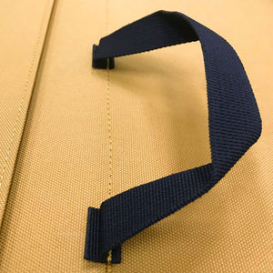 Black carry handle stitched into yellow crash pad.