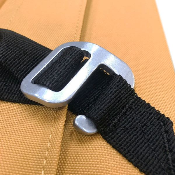 A hooked silver metal clip hooked into black material fixing. 