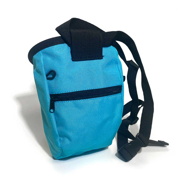Rear of blue fun chalk bag with zipped pocket, a black waist strap and a black drawstring closure.