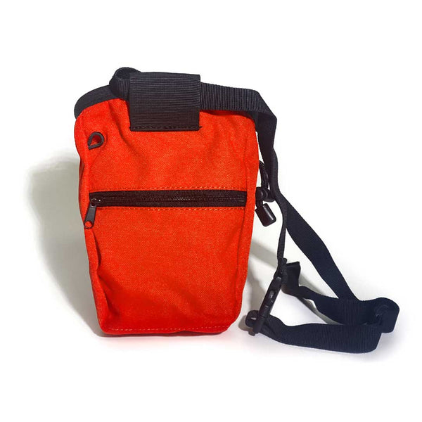 Rear of orange chalk bag with zipped pocket, a black waist strap and a black drawstring closure.