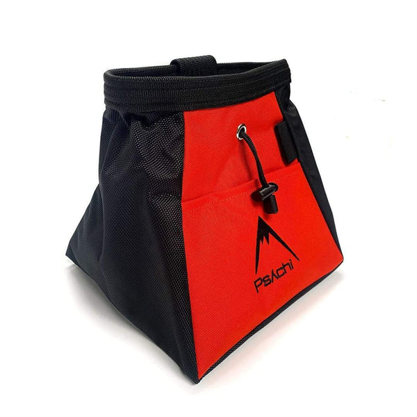 An orange and black bucket bag, with black mountain psychi logo, front pocket, a wide base, brush holder and a drawstring closure.